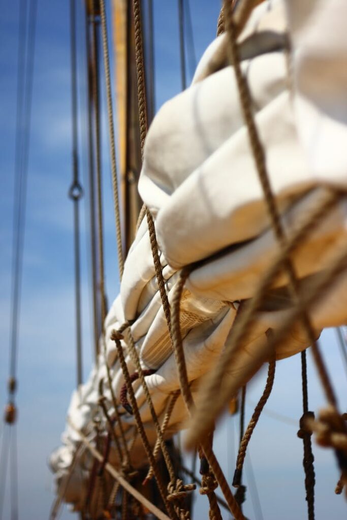 Detailed view of ropes and sails on a sailboat in natural light.